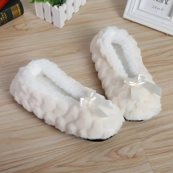 White fluffy slippers with a cute bow detail, perfect for cozy days at home.